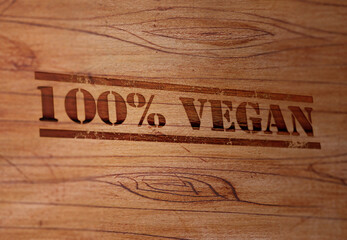 Vegan 100 Percent Stamp on a Wooden Surface