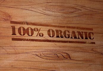 Organic 100 Percent Stamp on a Wooden Surface