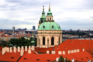 Fototapeta na wymiar Prague, Czech Republic. Mala Strana, Lesser Town of Prague. Top view of downtown, panorama, old buildings with red tiled roofs, church, tower, castle