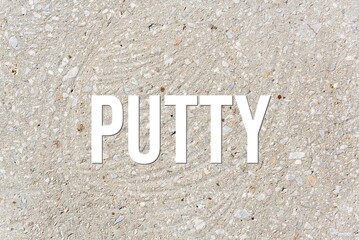 PUTTY - word on concrete background. Cement floor, wall.