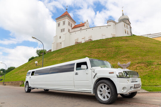 Grodno, Belarus - June 11, 2022: White limousine Hummer H3 at the city street waiting for a passengers.