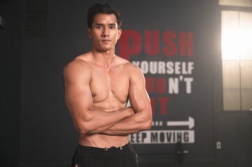 Fototapeta na wymiar Asia sport man with beautiful muscles at fitness gym