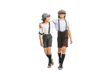 Two school age boys, stylish kids wearing retro clothes isolated over white background. Concept of childhood, vintage summer fashion style