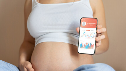 Pregnancy calendar app. Mobile pregnancy online maternity application. Pregnant mother using phone....
