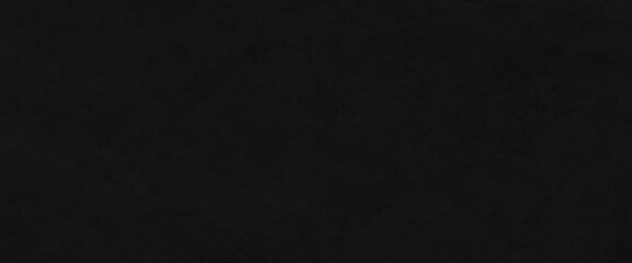 Black or dark gray rough grainy stone texture background, dark black grunge textured concrete backdrop background. Panorama dark grey black slate background or texture.