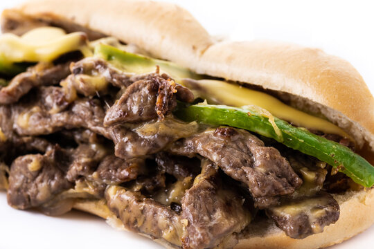 Philly cheesesteak sandwich with beef, cheese,green pepers and caramelized onion isolated on white background..Traditional philadelphia sandwich	