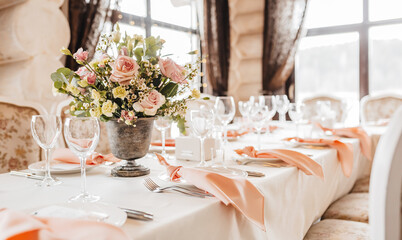 Luxury table setting for dining in a restaurant in pastel colors close up. Wedding party table set...
