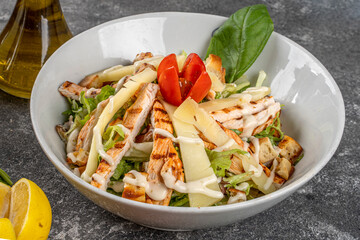 Healthy Grilled Chicken Caesar Salad with Cheese and Croutons with with salad dressings