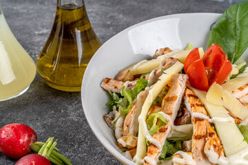 Healthy Grilled Chicken Caesar Salad with Cheese and Croutons with with salad dressings