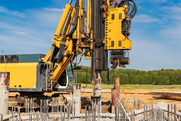 Hydraulic drilling machine at the construction site. Pile field. Modern drilling rig. The device of...