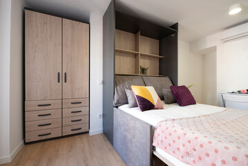 Fototapeta na wymiar Studio apartment with furniture with removable folding sofa bed and wooden floors