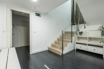 Stairs of a local with cream marble steps and black wooden floors