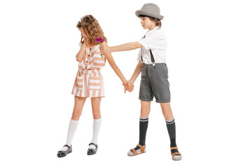 Fototapeta premium Portrait of little boy and girl, charming kids retro style outfit, fashion of 70s, 80s years isolated on white studio background with copy space for ad.