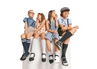 Group of emotional kids in retro style summer outfit sitting together isolated on white background....