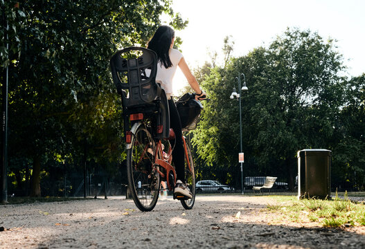 Woman with bike at the sempione park in Milan.