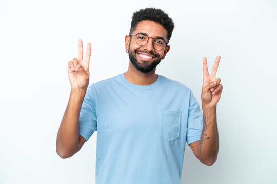 Young Brazilian man isolated on white background showing victory sign with both hands