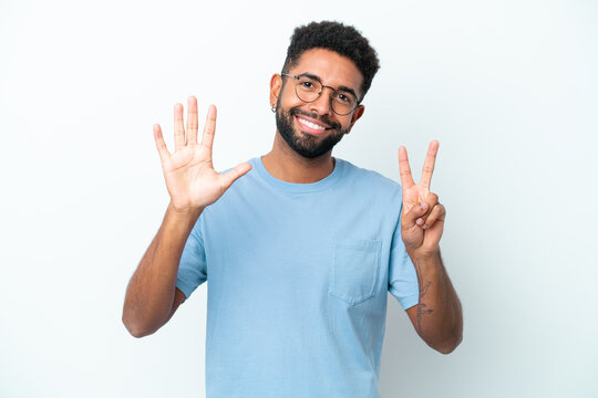 Young Brazilian man isolated on white background counting seven with fingers