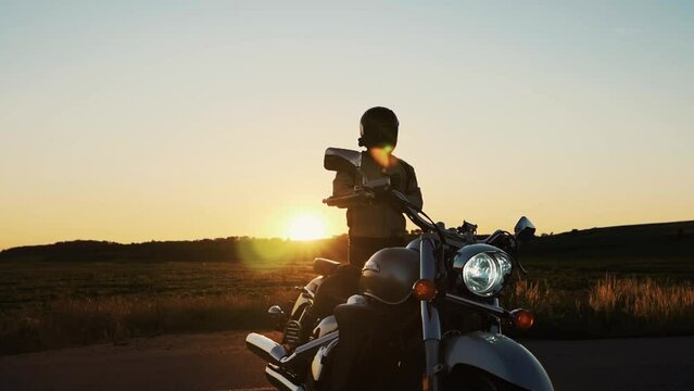 Portrait of confident motorcyclist man in motorcycle helmet