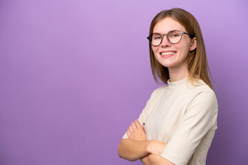 Young English woman isolated on purple background with arms crossed and looking forward