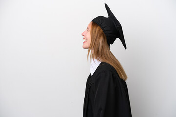 Young university graduate English woman isolated on white background laughing in lateral position