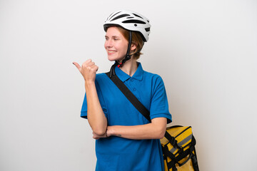 Young English woman with thermal backpack isolated on white background pointing to the side to present a product