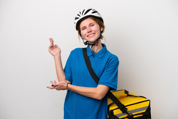 Young English woman with thermal backpack isolated on white background extending hands to the side for inviting to come