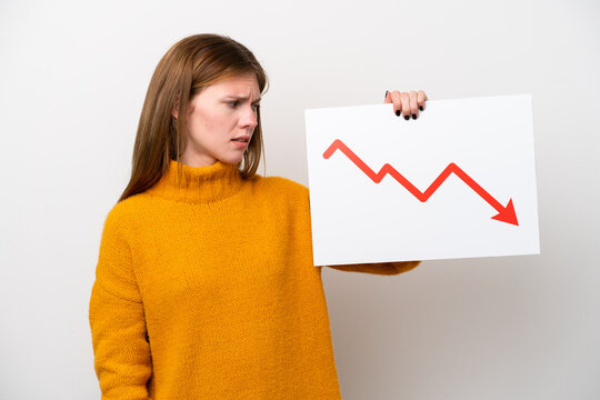 Young English woman isolated on white background holding a sign with a decreasing statistics arrow symbol with sad expression