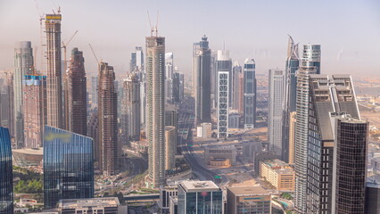 Downtown skyline with modern architecture form above timelapse. Aerial view of Dubai business bay towers.