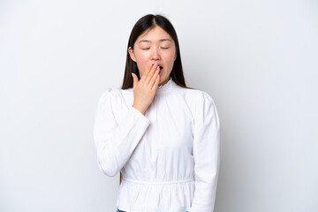 Young Chinese woman isolated on white background yawning and covering wide open mouth with hand