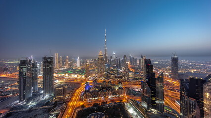Fototapeta na wymiar Aerial panorama view of tallest towers in Dubai Downtown skyline and highway day to night timelapse.