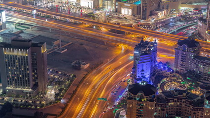 Fototapeta na wymiar Bussy traffic on the overpass intersection in Dubai downtown aerial night timelapse.