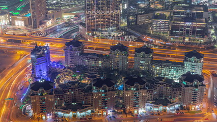 Naklejka premium Bussy traffic on the overpass intersection in Dubai downtown aerial night timelapse.