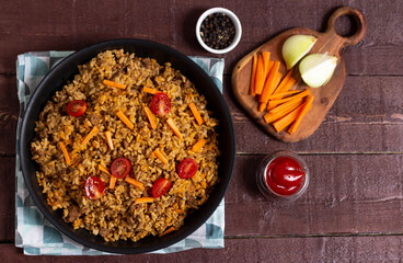 Rice in a frying pan on a napkin. View from above.