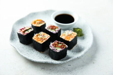 Assorted vegan sushi rolls with vegetables and tofu