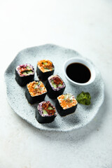 Assorted vegan sushi rolls with vegetables and tofu