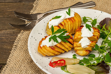 Baked accordion potatoes with fresh greens mix, fermented vegetables, and pea sprouts