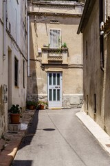 View of old street in Dalt la Vila, building with colored facade, historic center of Badalona, province of Barcelona, Spain.