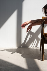 Women's hands, shot in harsh sunlight with fashionable shadows.