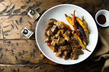 Homemade meat ragout with roasted carrots