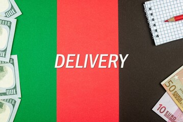 DELIVERY - word (text) and money dollars and euros on a table made of different colors, a notepad and a red pencil. Business concept, buy, sell, exchange (copy space).