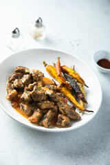 Homemade meat ragout with roasted carrots