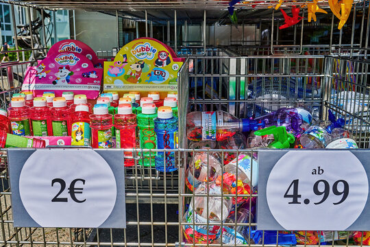 Berlin, Germany - June 22, 2022: Sales stand with various colorful containers for soap bubbles and other summer toys.