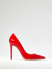 red women's shoe with high heels on a white background