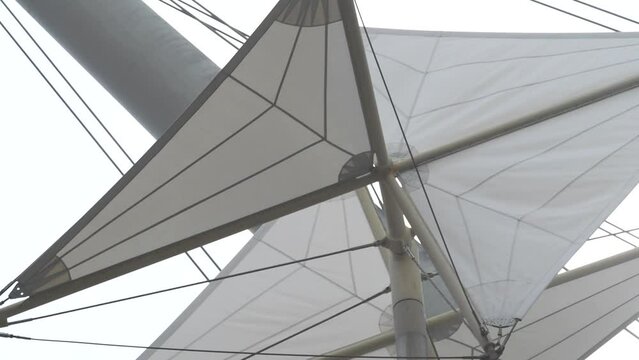 Genova, Liguria, Italy. 03/05/2022. Windmills at the ancient port. Kinematic sculptures moving in the wind, ancient port of Genoa. Designed by Renzo Piano.