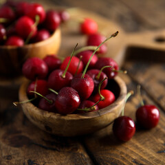 Fresh ripe cherries in a wooden bowl