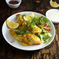 Roasted fish with almond flakes
