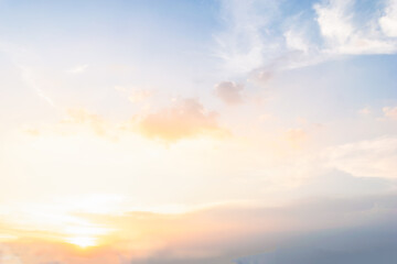 Sky blue and orange light of the sun through the clouds in the sky