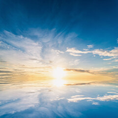 Sky blue and orange light of the sun through the clouds in the sky