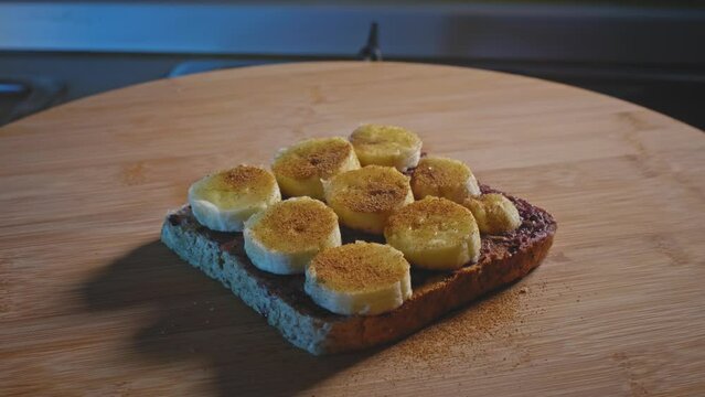 Wholemeal Toast With Blueberry Jam, Peanut Butter, Ripe Banana Slices, And Cinnamon Powder. rack focus, zoom-out