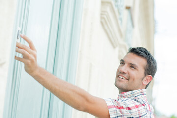 Young man ringing at the door